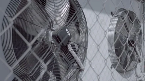Air conditioning unit with two rotating fans on the wall of the building Stock Footage 64700113