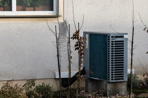 Air conditioning unit in yard during autumn day Photos