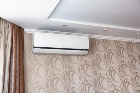 Air conditioning on the wall inside the room in apartment, switched off. Stock Photos