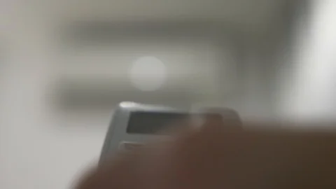 Air-conditioning is a wireless remote control in the hands for adjusting the Stock-Footage 86969527