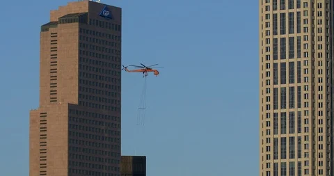 Air Crane removing material from down town skyscraper. Stock Footage 89145079