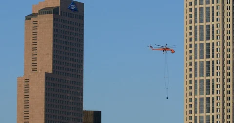 Air Crane removing material from down town skyscraper. Stock Footage 89146909