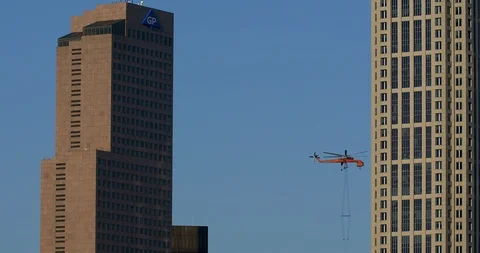 Air Crane removing material from down town skyscraper. Stock Footage 89147874