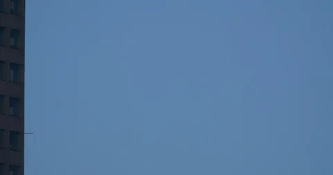 Air Crane removing material from down town skyscraper. Stock Footage 89148553