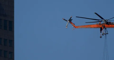 Air Crane removing material from down town skyscraper. Stock Footage 89149375