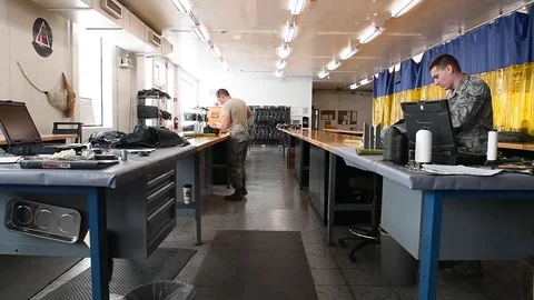 Air crew equipment riggers servicing parachutes in workshop 스톡 동영상 104855441