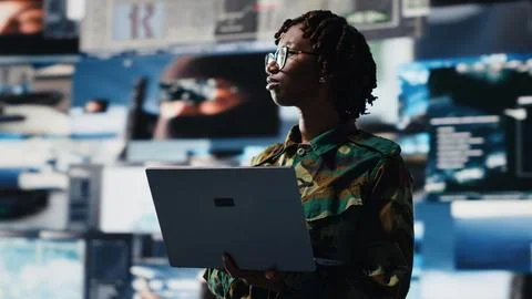 Air defense commander using radar systems on laptop program to detect missiles Stock Photos