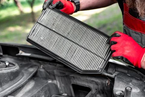 Air filter of an internal combustion engine in the hands of a mechanic. Fil.. Stock Photos