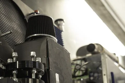 Air filter on machine engine in industrial setting Stock Photos