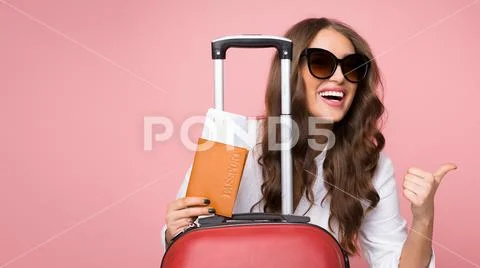 Air flight journey. Woman with suitcase showing thumb up Stock Photos