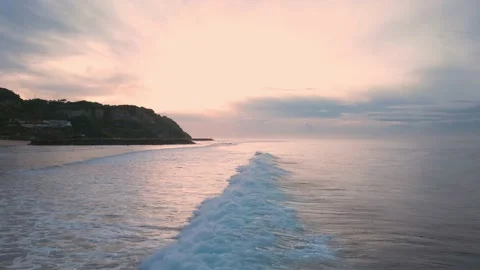 Air flight over the ocean with waves against the backdrop of dawn. Stock Footage 239297614