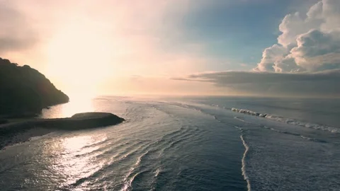 Air flight over the ocean with waves against the backdrop of dawn. Slow motio Stock Footage 239297869