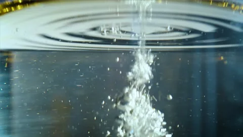 Air flow goes into water surface. Clean water with brown oil. Stock Footage 162113670