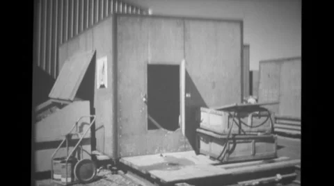 Air Force captain entering shipping crates used as an office Stock Footage 37596356