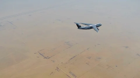 Air force cargo plane over Middle East desert 4K Stock Footage 85091622