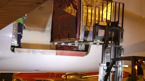 Air Freight container being loaded into a aircraft's cargo hold by fork hoist. Stock Footage 41316224