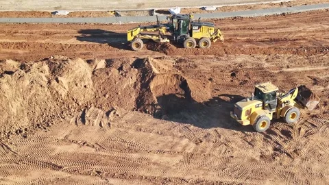 From the air a grader and front end loader working at a construction site Stock Footage 278340222