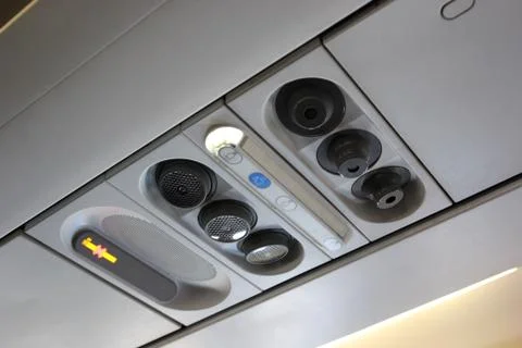 Air grille diffuser and lamp on ceiling  in the airplane Stock Photos