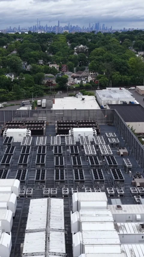 Air handlers and condenser rows cover a data center roof in Clifton, New Stock Footage 345728306