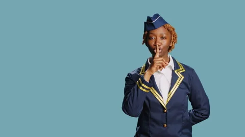 Air hostess doing hush privacy symbol on camera Stock Footage 235396810