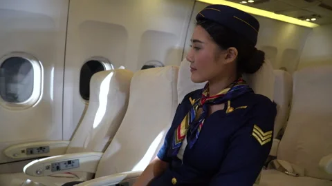 Air hostess sittig in airplane Stock Footage 147239676