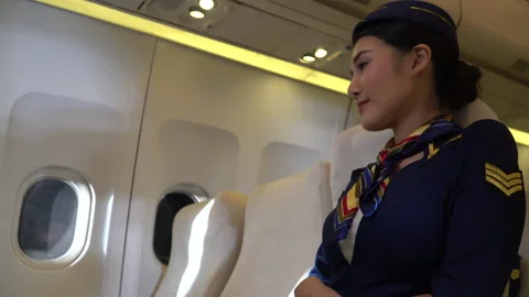 Air hostess sittig in airplane Stock Footage 147239686