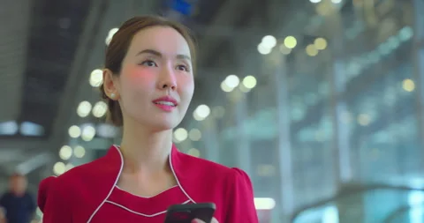 Air hostess using phone at escalator in airport. Stock Footage 246144528