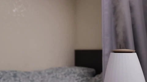 Air humidifier in the bedroom, ultrasonic diffuser on the table,Modern home.. Stock Footage 262145513