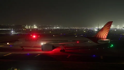 Air India Boeing 787 Passenger Airplane Hold for Takeoff at Mumbai Airport Night Stock Footage 253528833