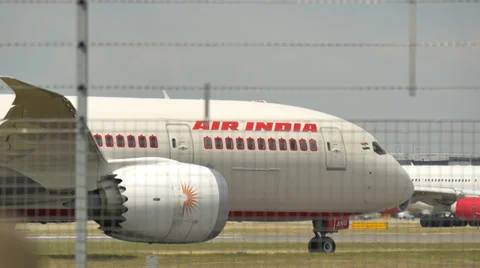 Air india passenger jet taxis for takeoff, through barbed wire fence, heathro Stock Footage 39889374