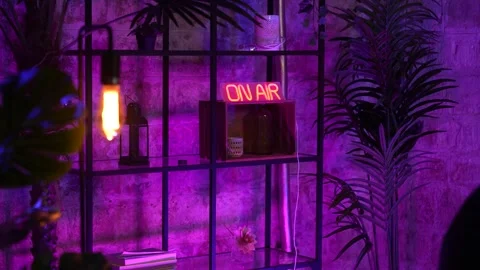 On air neon lamp on a shelf inside modern decorated room with purple Stock Footage 262630177