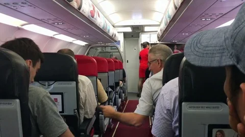Air passengers get ready for the flight on board of AirAsia Stock Footage 77020792