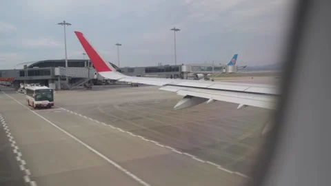 Air plane about to take off from cabin view left wing - 4k footage travel video Stock Footage 245554012