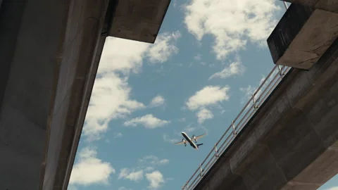 Air plane flying over sky train tracks | Vancouver, BC Stock Footage 244542771