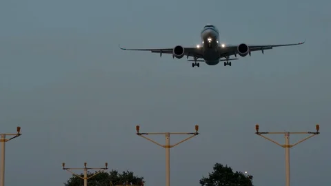 Air Plane landing during sunset. Flying over runway threshold. Evening 4K Stock Footage 120792195