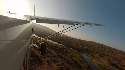 Air plane side view flying over river and savannah at morning Stock-Footage 310968306
