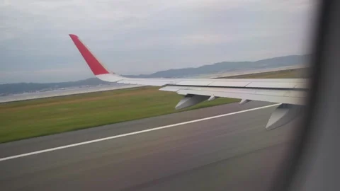 Air plane taking off from cabin view left wing - 4k footage travel video Stock Footage 245554017
