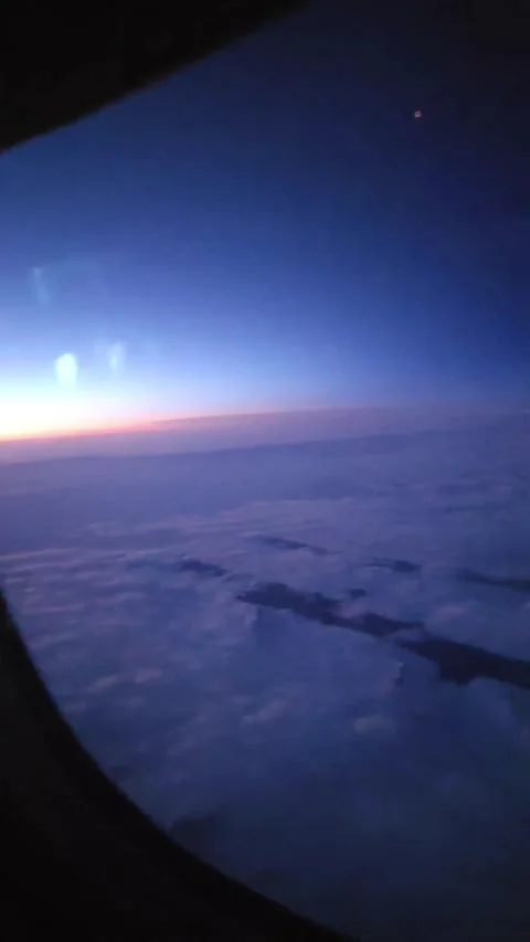 Air plane Window Panning Shot of Clouds and Blue Sky Stock Footage 340359824