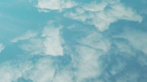 Air plane window view, aerial drone view, 4K white clouds and clear blue sky dur Video stock 332921376