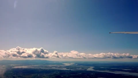Air plane window view time lapse clouds and blue sunny sky 스톡 동영상 262120010