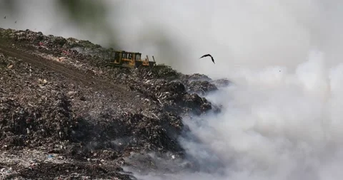 Air pollution caused by fire on dump site. Clouds of smoke above the waste land Stock Footage 157353610