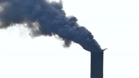 Air pollution from dark smoke factory smokestack Stock Footage