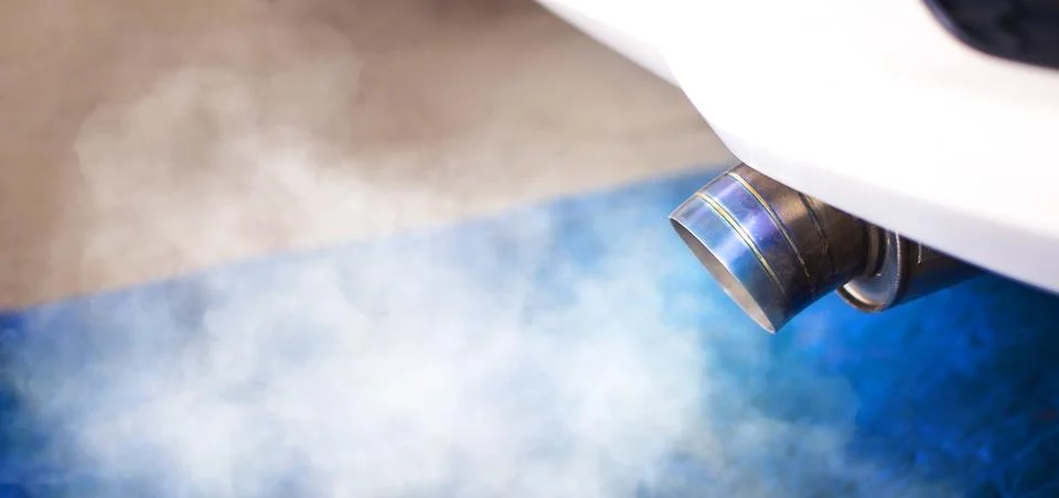 Air pollution of problem engine with white smoke , titanium car exhaust pip.. Stock Photos