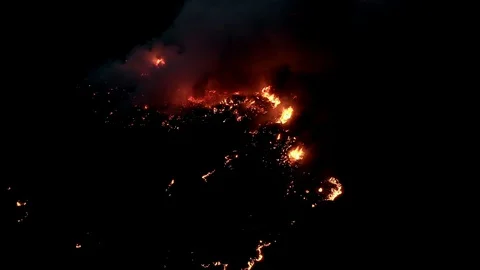 Air shot, of fire flame in the dark night . A terrible dangerous wild fire at Stock Footage 127598456