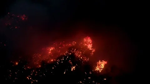 Air shot, of fire flame in the dark night . A terrible dangerous wild fire at Stock Footage 127598592