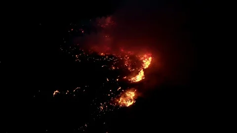 Air shot, of fire flame in the dark night . A terrible dangerous wild fire at Stock Footage 127598751