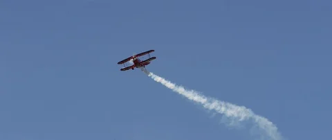 Air show, bright red Pitts S1-E biplane aerobatic plane in the blue sky. Stock Footage 101268702