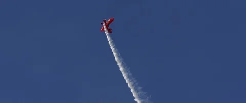Air show, bright red Pitts S1-E biplane aerobatic plane in the blue sky. Stock Footage 101312970