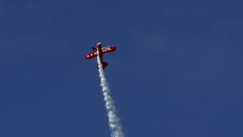 Air show, bright red Pitts S1-E biplane aerobatic plane in the blue sky. Stock Footage 101321762