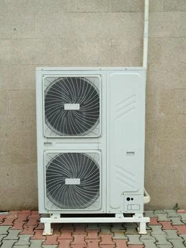 Air source heat pump installed in building. Sustainable and clean energy Fotos de archivo